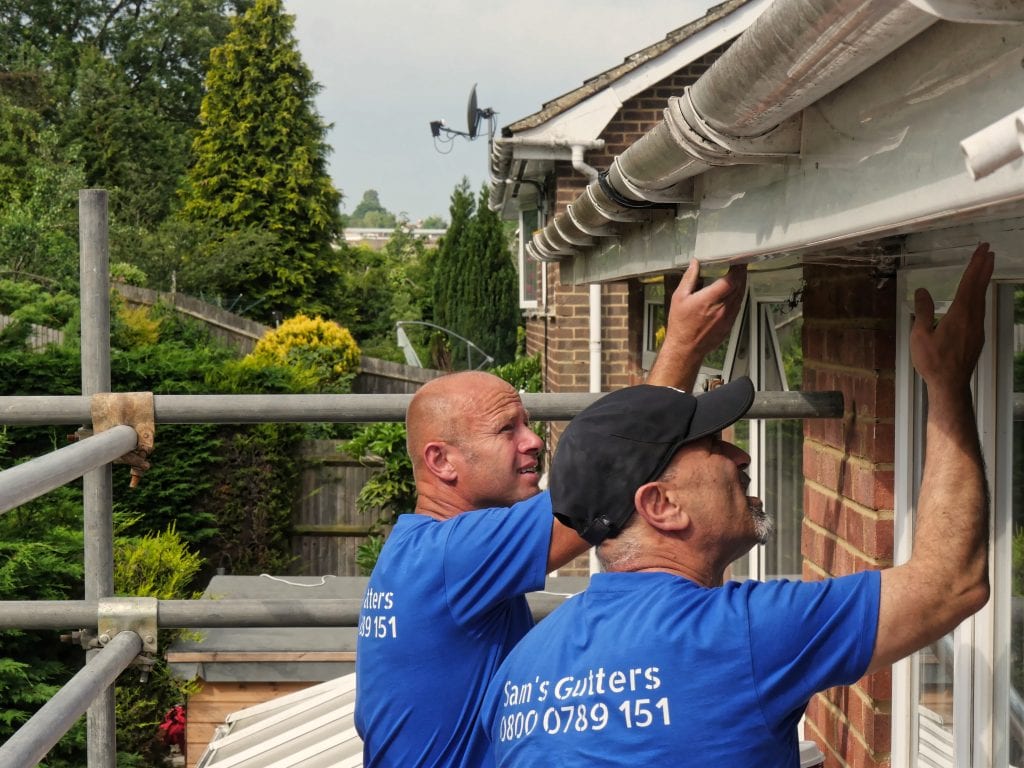 Technicians preparing for a gutter repair