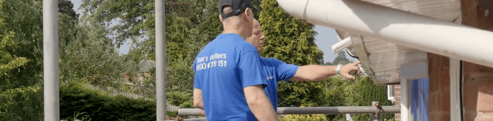two gutter techs check fascia