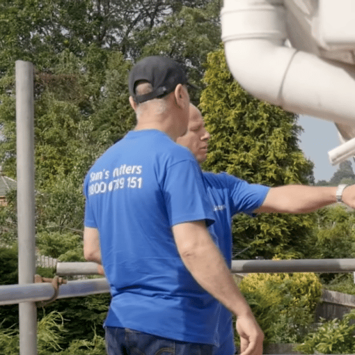 two gutter techs check fascia