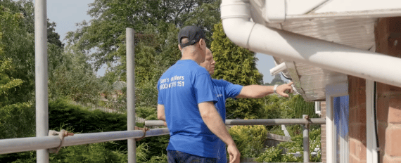 two gutter techs check fascia