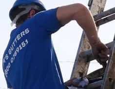 man gutter cleaning on ladder
