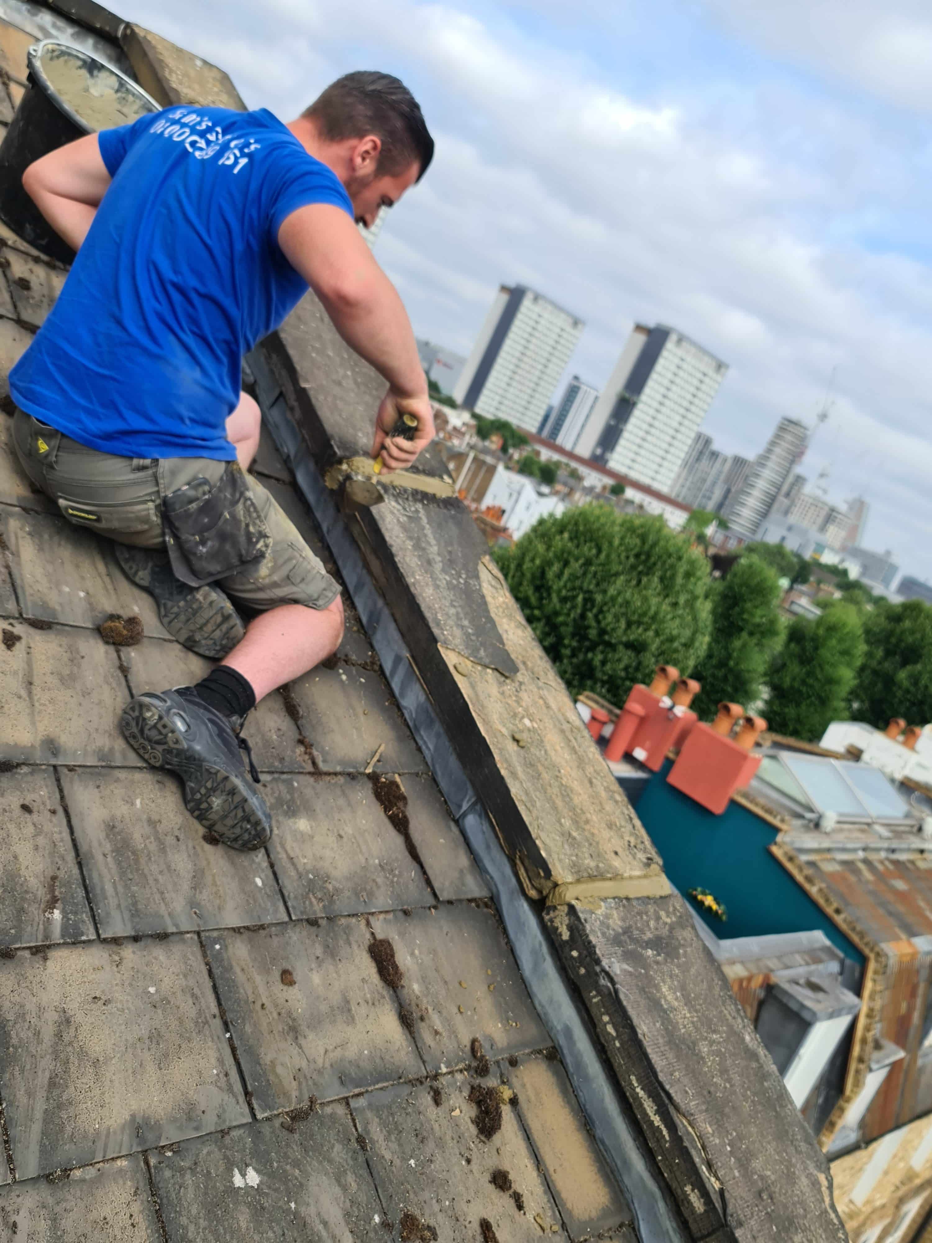 Roofer repairing high rise roof looking over London