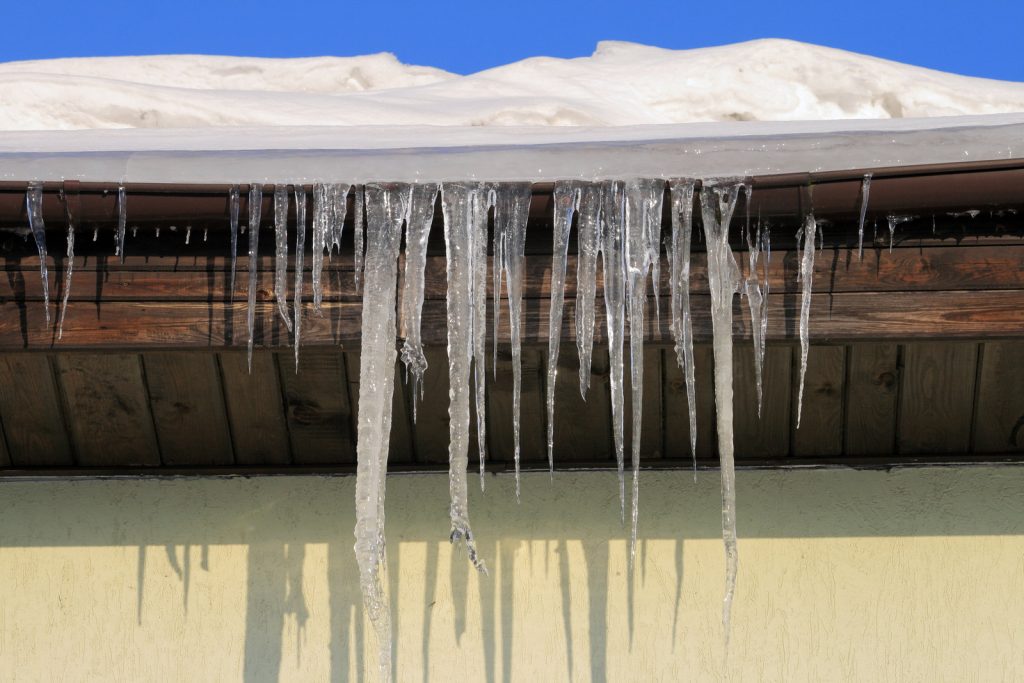 icicles hanging from gutters off roof
