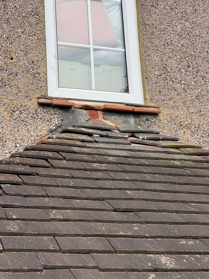 Sam's Gutters technician clearing out a gutter