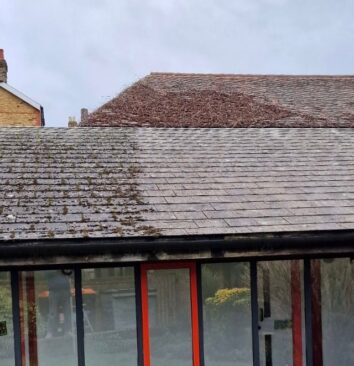 A roof that is half cleaned.