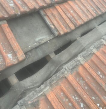 A damaged roof with missing tiles.