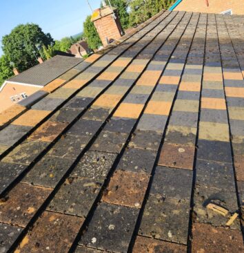 Showing part of a roof that has been cleaned and part that hasn't.