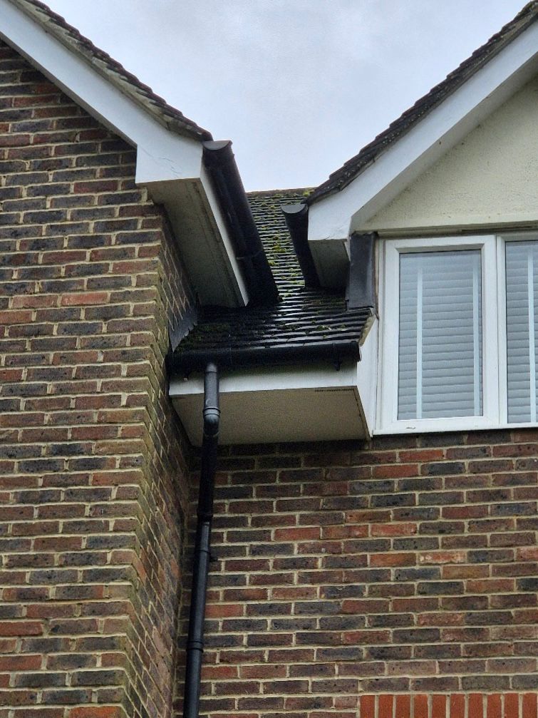 Looking up at a second storey gutter on a residential property.
