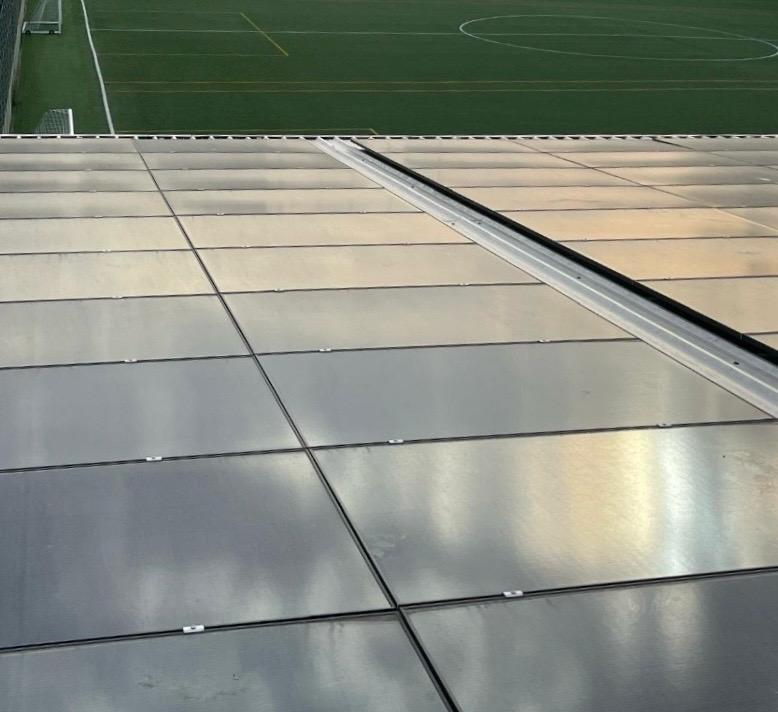 The roof of a commercial property with a football pitch.