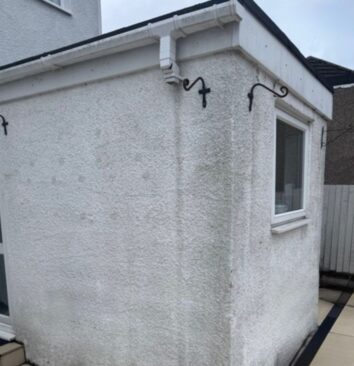 A before image of a white property with a missing white UPVC downpipe.