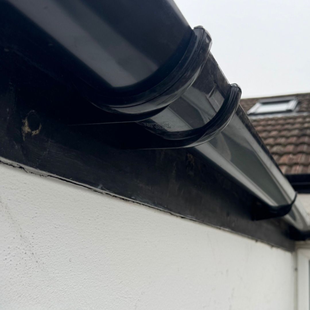 A newly installed black UPVC gutter.