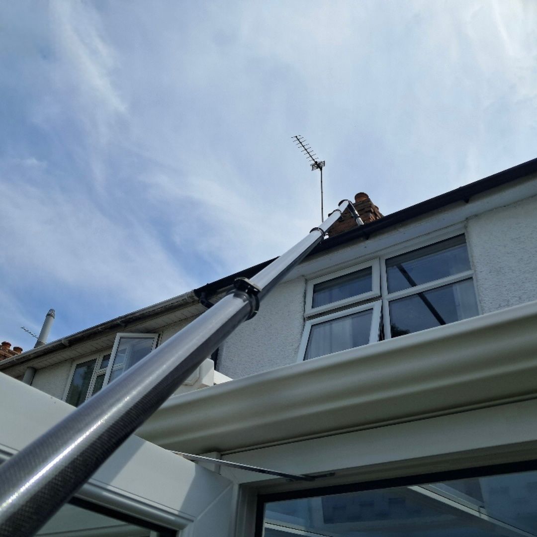 Sky Vac system being used to reach a second storey gutter over a conservatory.
