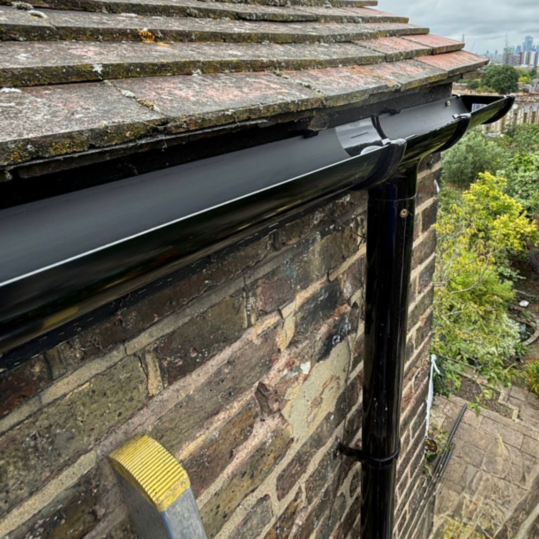 A newly installed black UPVC gutter.
