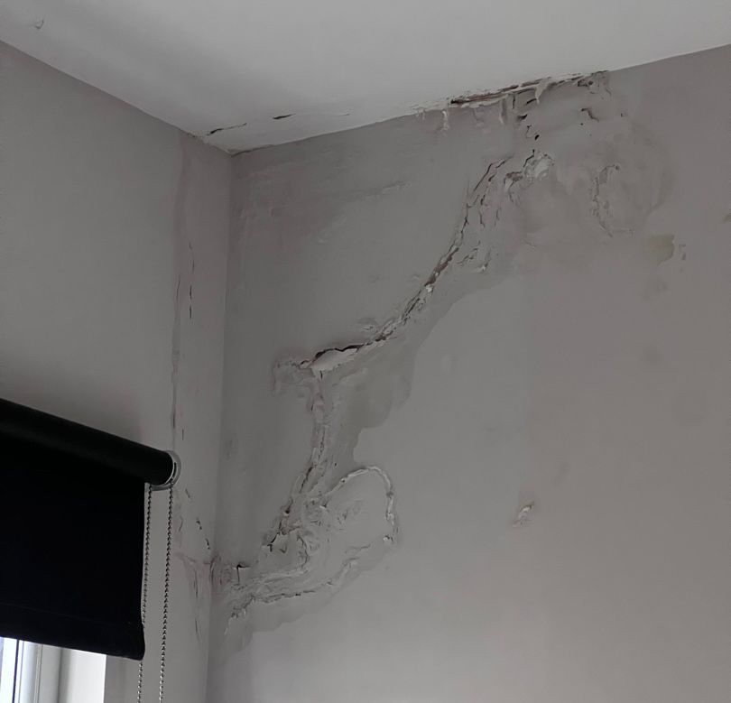 A damp patch on a wall inside a home.
