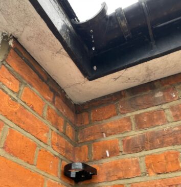 A missing downpipe on a brick house.