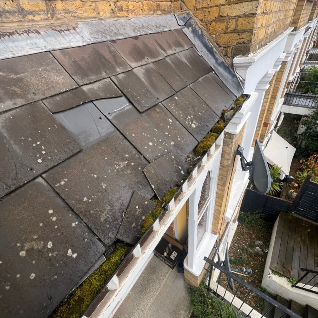Slipped slate roof tiles.