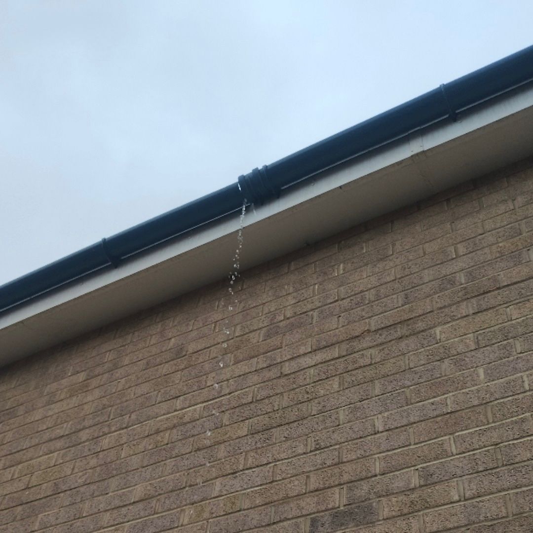 A leaking black UPVC gutter.