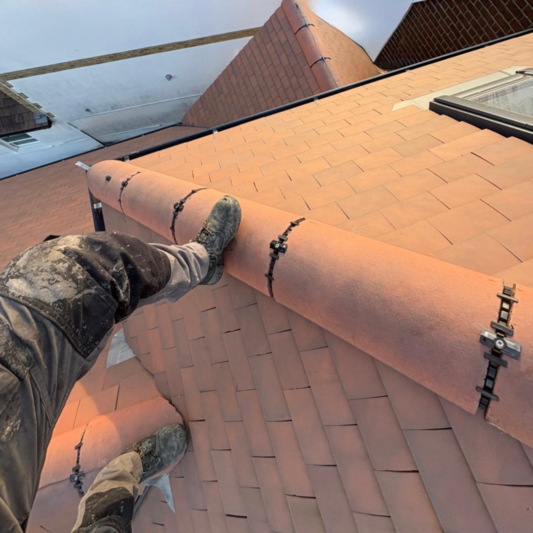 A roofers point of view looking down while working on top of a 4 storey building.