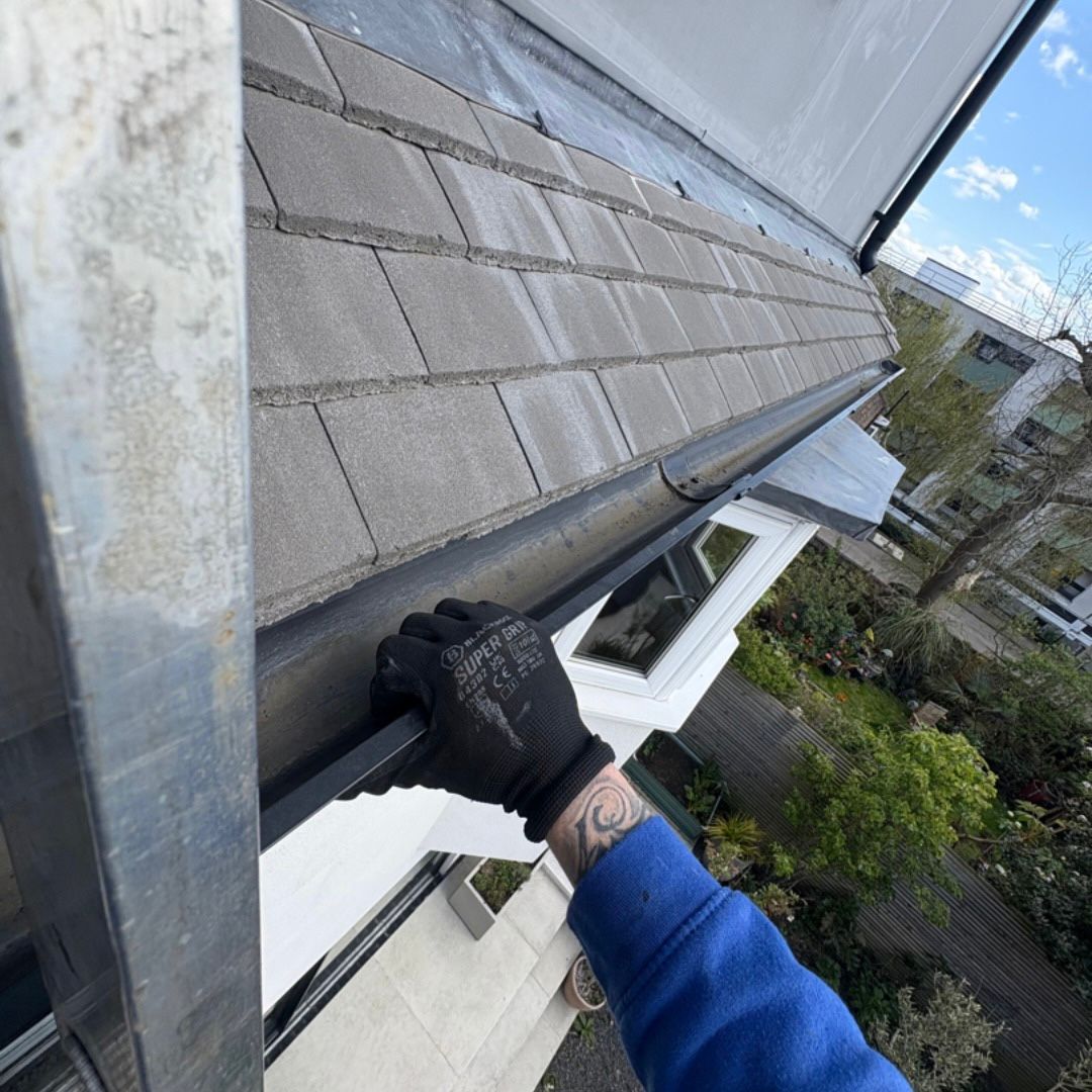 Showing a black UPVC gutter which has been cleared.