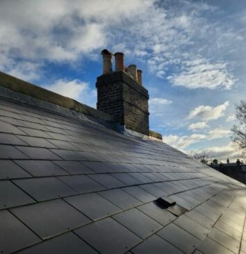 A roof with a slight reflection from the sun.