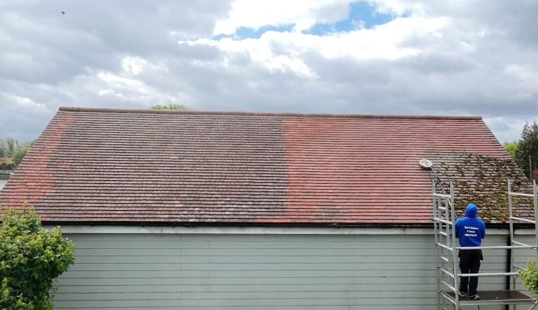 Photo of Sam's Gutters cleaning a roof.