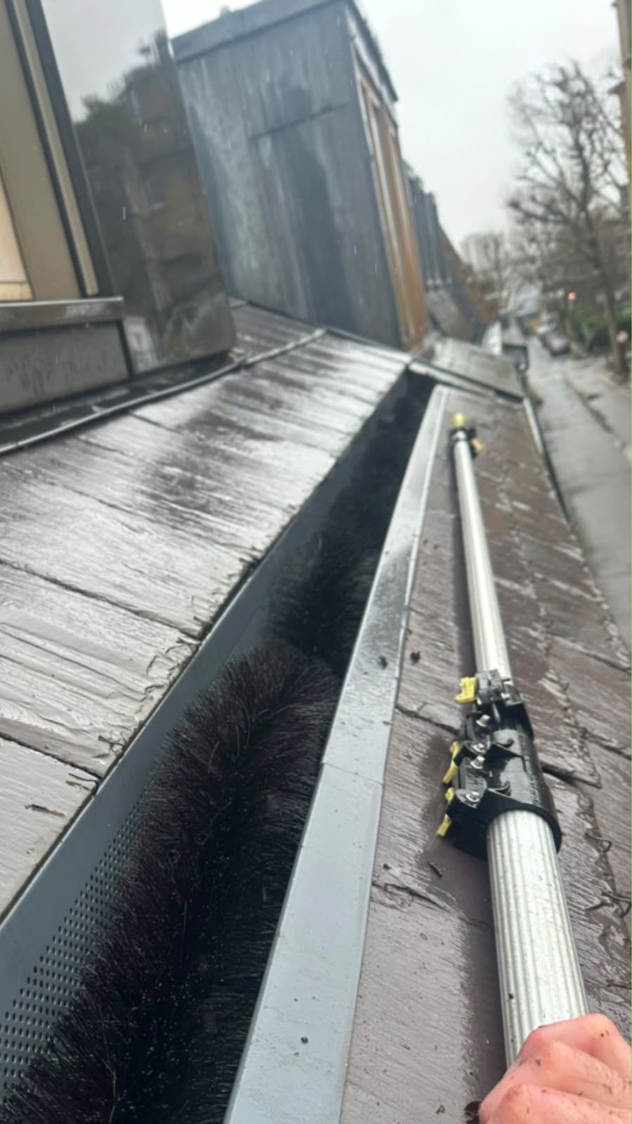 Photo of a commercial roof cleaned by Sam's Gutters.